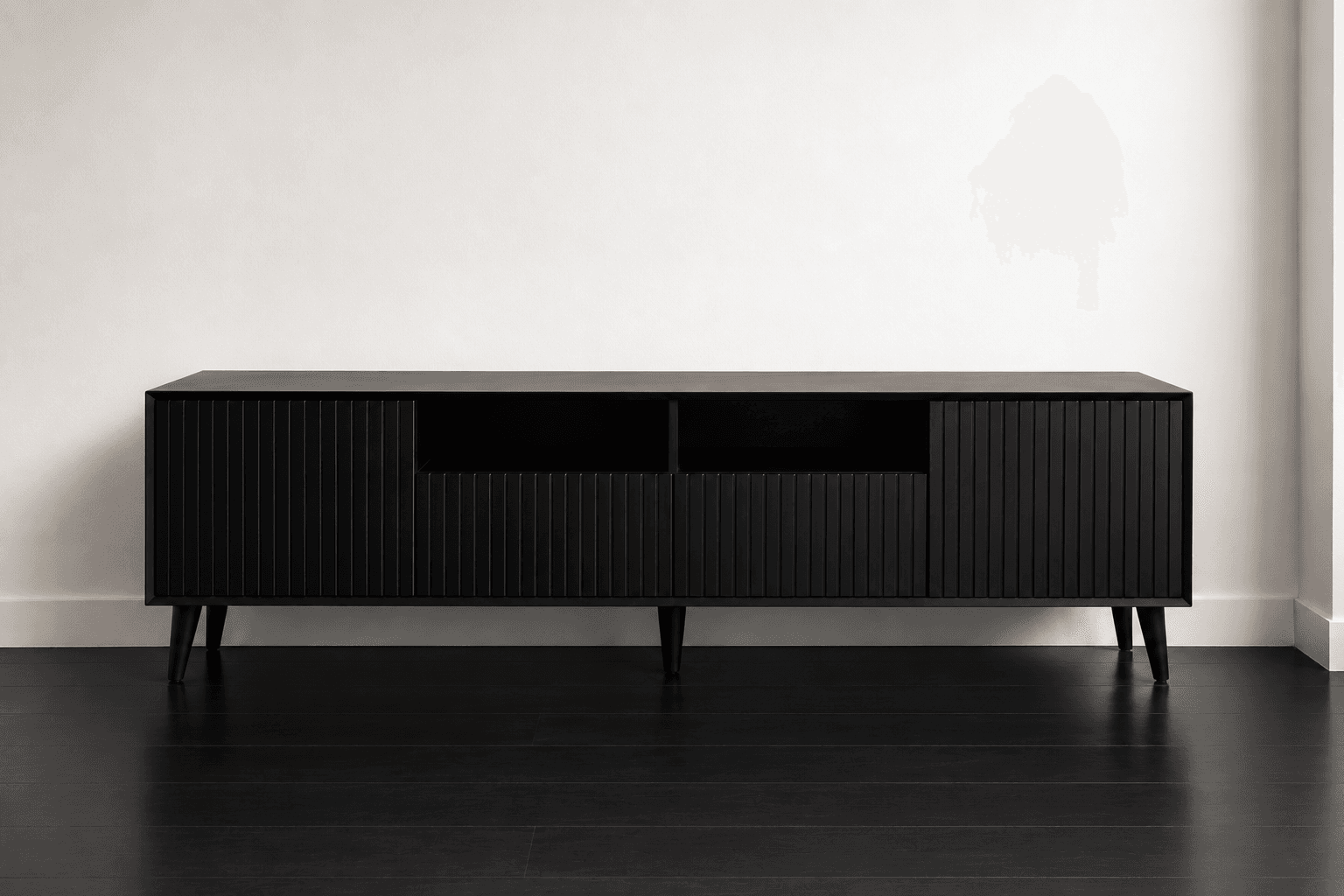 Front elevation of a black fluted NDB media console on tapered legs.