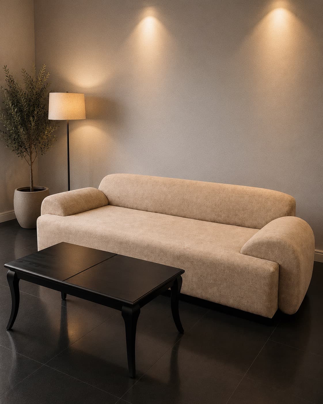 NDB deep-seated greige sofa with a black ebony coffee table in a warmly lit Kigali living room.